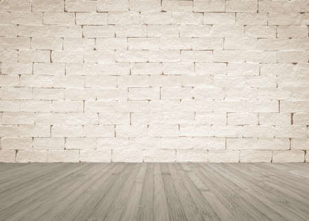 Grunge old aged brick wall painted in light beige with wooden floor in light sepia grey for interior...