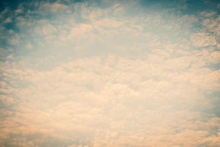 Blurred nature background of scattered clouds on sky in cool vintage colorの写真素材