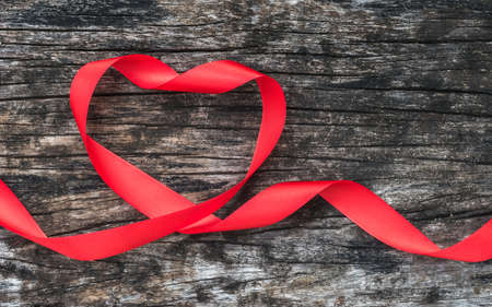 Red heart shaped ribbon awareness on old aged wood for World aids day conceptの写真素材