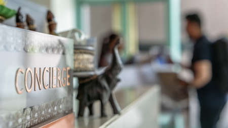 Concierge service counter of hotel, restaurant or apartment's front desk in luxury reception hall in Thailand with staff working for serving tourist guest or check-in customersの写真素材