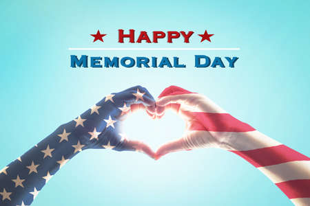 Happy memorial day with America flag pattern on people hands in heart shapeの写真素材