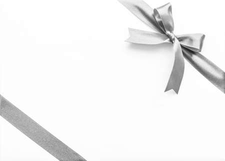 Silver pearl satin ribbon stripe corner fabric bow isolated on white backgroundの写真素材