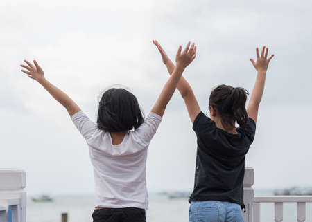 Happy kids at sea pier on seashoreの写真素材