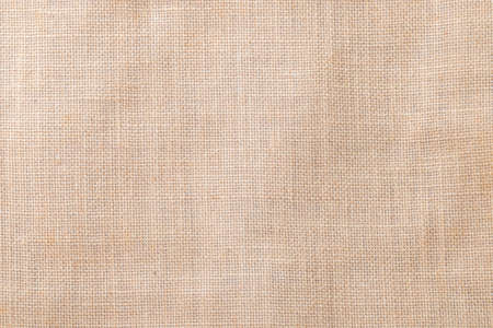 Hessian sackcloth woven texture pattern background in light cream beige brown colorの写真素材
