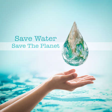 World ocean day,, saving water campaign, sustainable ecological ecosystems concept with green earth on woman's hands on blue sea backgroundの写真素材