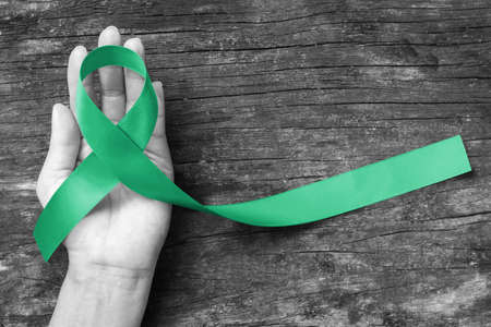 Kelly green ribbon awareness symbolic concept raising awareness on people living with Gallbladder, Bile Duct Cancer and living organ donation の写真素材