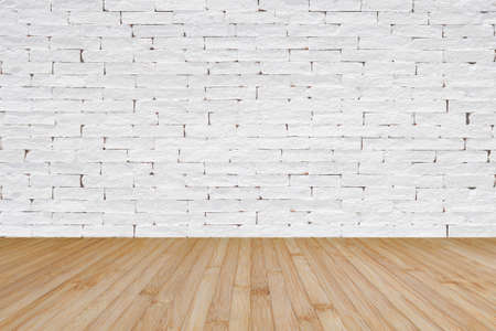 Brick wall painted in white with wooden floor textured background in natural yellow brownの写真素材