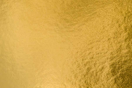 Gold foil leaf shiny wrapping paper texture background for wall paper decoration elementの写真素材