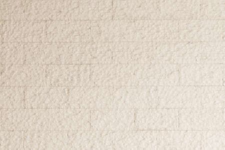 Modern rough marble rock tiled detail wall texture pattern background in pastel yellow cream color の写真素材
