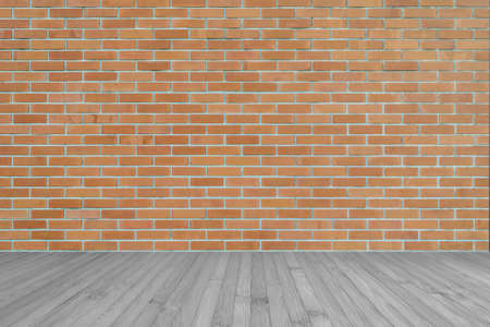Dark orange brown brick wall texture background with wooden floor in greyの写真素材