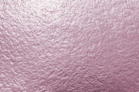 Rose gold pink purple color shiny paper foil leaf texture background with bright brilliant reflective glossy metallic material surfaceの写真素材