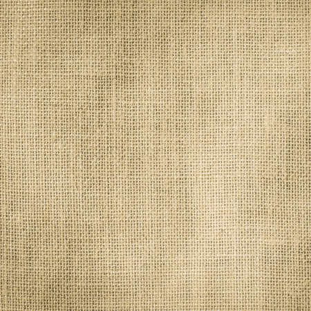 Hessian sackcloth woven texture pattern background in light cream yellow beige earth tone color の写真素材