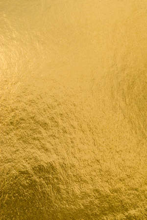 Gold foil leaf shiny wrapping paper texture background for wall paper decoration elementの写真素材