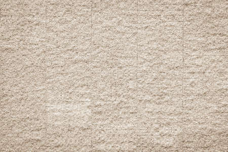 Rustic grunge granite tiled wall detailed pattern texture in natural light beige cream sepia colorの写真素材