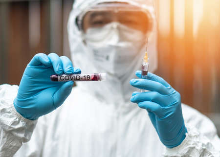 COVID-19, Corona Virus epidemic disease with doctor in PPE Personal Protective Equipment holding...