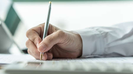 Paperwork document, claim form with business applicant or administrative person filling in company agreement or legal contract paper applying for job, or registering for health insuranceの写真素材