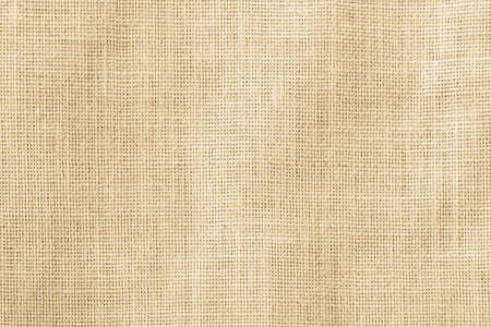 Hessian sackcloth woven texture pattern background in yellow beige cream brown colorの写真素材