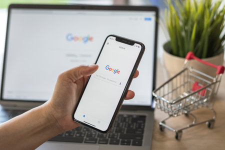 Bankok, Thailand. March 17, 2018: Google application with voice speaker typing, intelligent search engine sign up page on mobile app touchscreen on iphone and on computer screen displayのeditorial素材