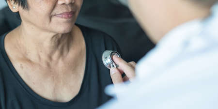 Elderly patient heart health check by medical geriatric doctor for awareness in stroke systolic high blood pressure, hypertension, hypotension and cardiovascular disease in aged senior older womanの写真素材
