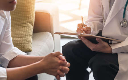 Menopause woman, stressful patient consulting with doctor or psychiatrist who diagnostic examining on obstetric - gynaecological female illness, or mental health in medical clinic or hospitalの写真素材