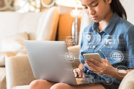 Internet of things - IOT and digital marketing via multi-channel communication network concept with young student or teenager girl using computer, mobile smartphone app  technology studying at homeの写真素材