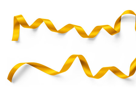 Gold ribbon satin bow scroll set isolated on white background with clipping path for Christmas and wedding card confetti design decorationの写真素材