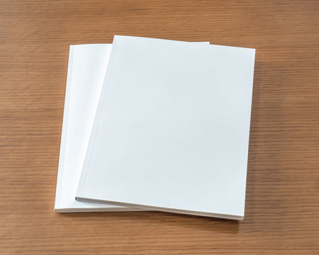 Book mockup with blank white front cover page a4 paperback mock up for catalog, magazine, menu, booklet, notebook, portfolio design template on wood table backgroundの写真素材