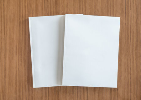 Book mockup with blank white front cover page a4 paperback mock up for catalog, magazine, menu, booklet, notebook, portfolio design template on wood table backgroundの写真素材