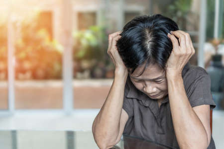 Dementia, Alzheimer's disease elderly senior patient (old aged women) with depression, mental stress illness, memory loss, schizophrenia, or cervical vertigo symptomの写真素材