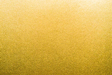 Gold foil texture background metallic golden shinny wrapping paper bright yellow wall paper for design decoration elementの写真素材