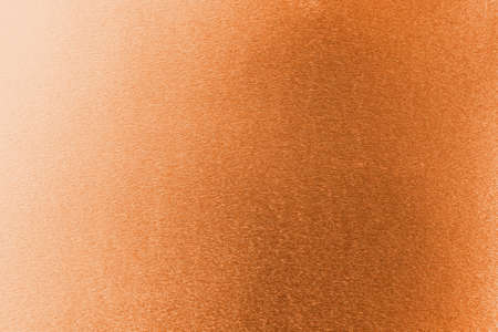 Copper gold background foil leaf metallic texture wrapping paper shiny orange for wallpaper decoration elementの写真素材