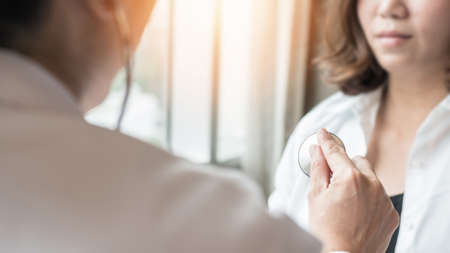 Doctor examining patient health on coronary artery disease, blood vessel or congenital heart defect, heart rhythm problem, arrhythmias, cardiovascular illness in medical clinic by checking heartbeatの写真素材