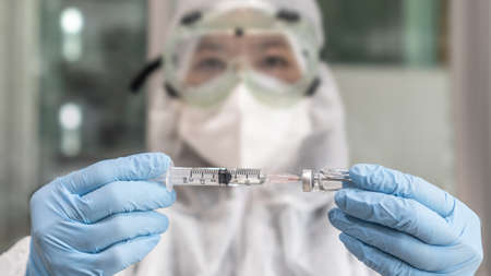 Vaccine for covid-19 coronavirus vaccination, medical immunization with doctor or scientist in PPE...