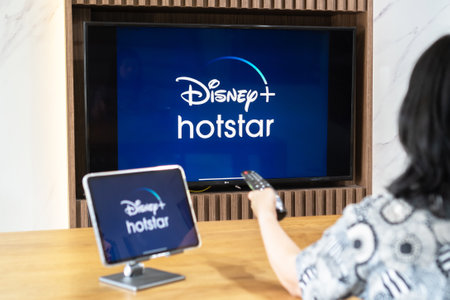 Bangkok, Thailand - July 13, 2021: Disney+ Hotstar movie app logo on ipad and smart TV television...