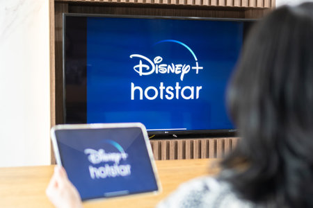 Bangkok, Thailand - July 13, 2021: Disney+ Hotstar movie app logo on ipad and smart TV television...