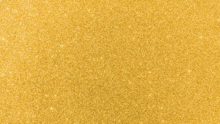 Gold glitter texture background sparkling shiny wrapping paper for Christmas holiday seasonal wallpaper  decoration, greeting and wedding invitation card design elementの写真素材