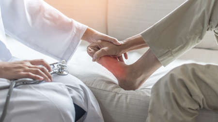 Plantar Fasciitis or heel pain illness in feet of woman patient who having medical exam with orthopaedic doctor on aching tendon, inflammation or disorder of the connective tissue on foot and toeの写真素材
