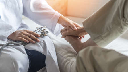 Plantar Fasciitis or heel pain illness in feet of woman patient who having medical exam with orthopaedic doctor on aching tendon, inflammation or disorder of the connective tissue on foot and toeの写真素材