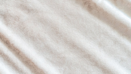 Beige gold velvet background or velour flannel texture made of cotton or wool with soft fluffy velvety satin fabric cloth metallic color materialの写真素材
