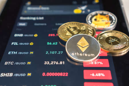 Ethereum cryptocurrency on Binance trading app, Bitcoin BTC with BNB, Dogecoin, Cardano, Litcoin, altcoin digital coin crypto currency defi p2p decentralized finance and fintech banking marketの写真素材
