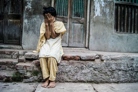 Puran Dhaka, May 11, 2012 : A street girl was ashamed when i was taking pictures & hiding her smilesのeditorial素材