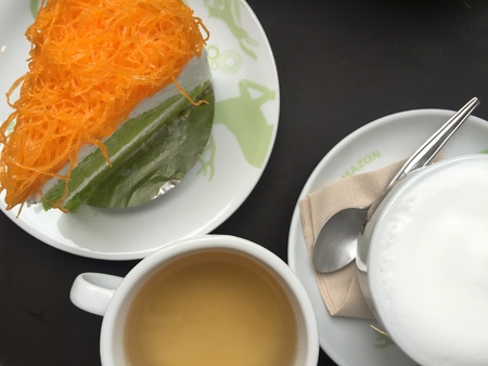 piece of cake with tea and hot milk on the tableのeditorial素材