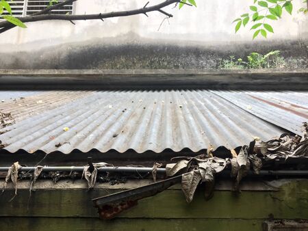 Broken gutter with more leafの写真素材