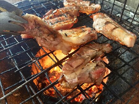 Closeup pork grill on fire placeの写真素材