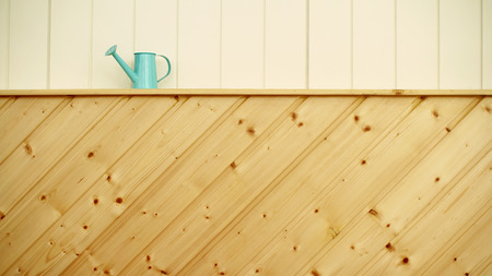 watering can and wooden backgroundの写真素材