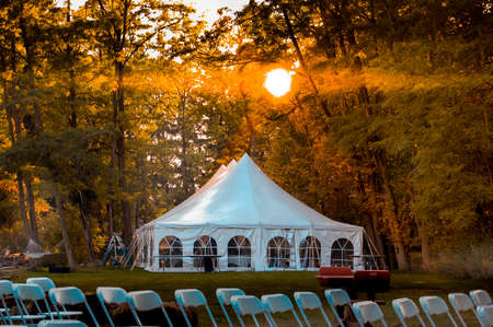 Large wedding reception tent in wooded areaの写真素材