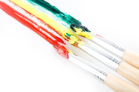 used paint brushes of different colorsの写真素材