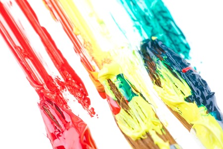 used paint brushes of different colorsの写真素材