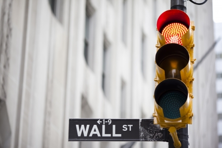 Wall street and red traffic  lightの写真素材