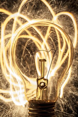 bulb and sparklers on black backgroundの写真素材